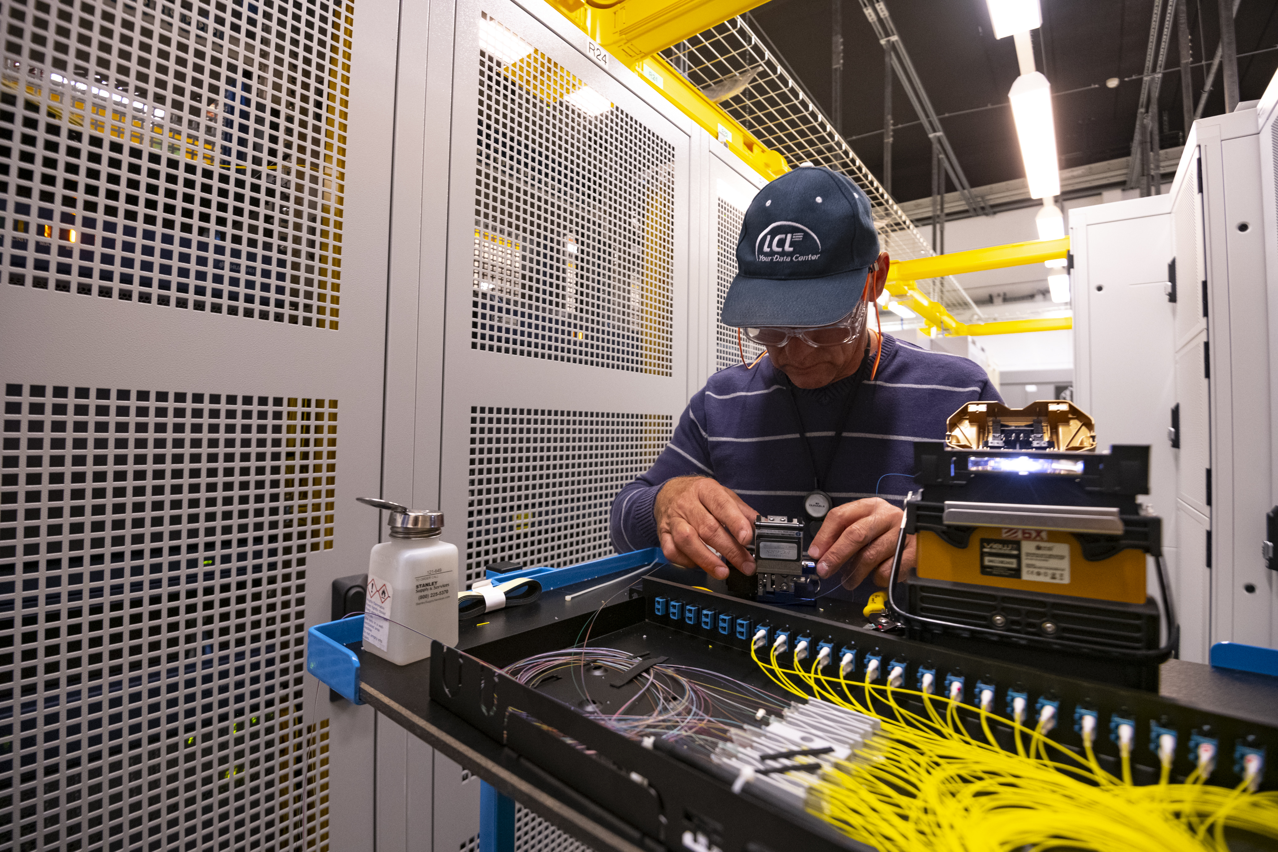 Werknemer bekijkt en werkt aan kabels voor connectiviteit datacenter